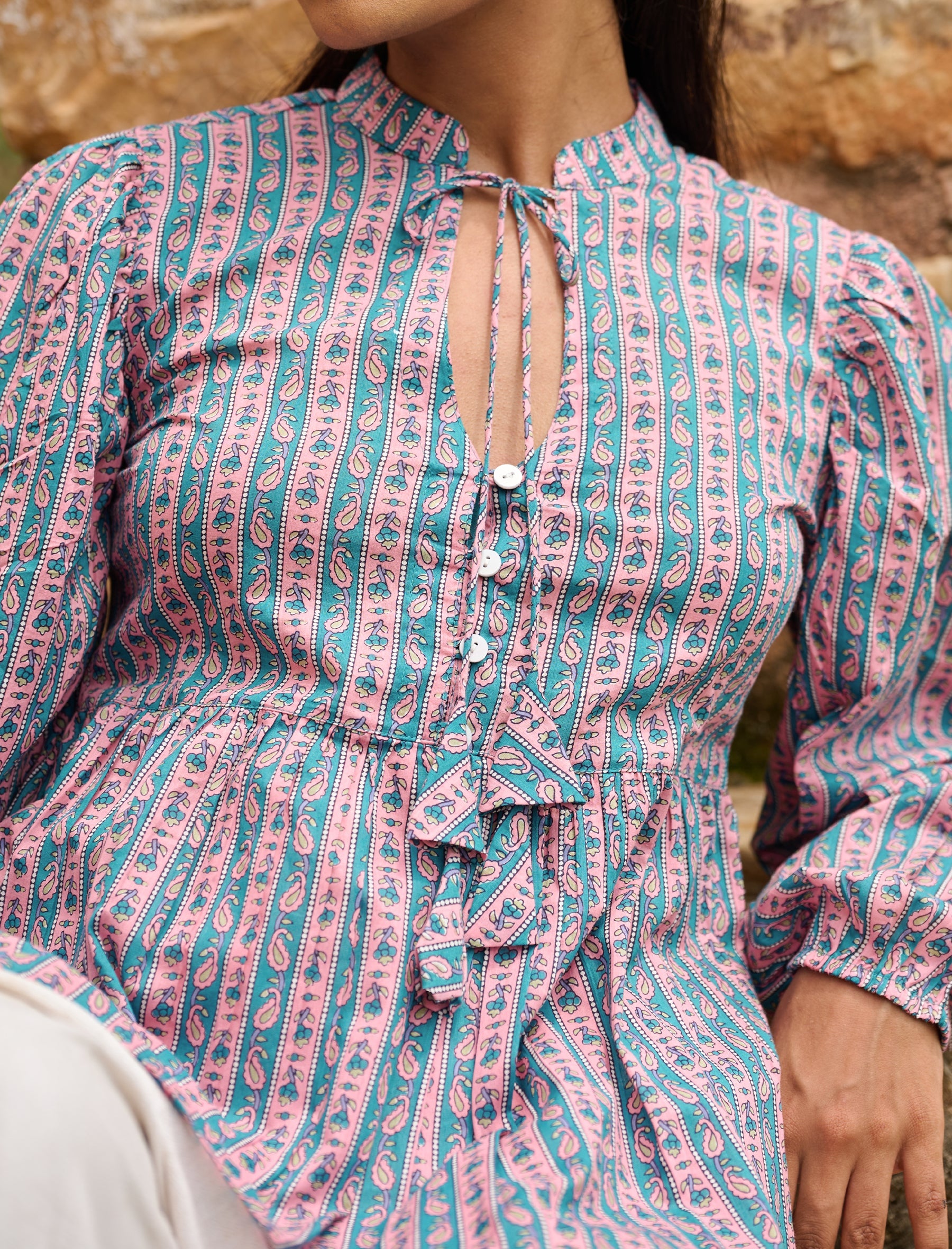 Peplum top with tie-up neckline